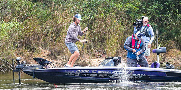 Tristan Mccormick Swinging a bass into his boat